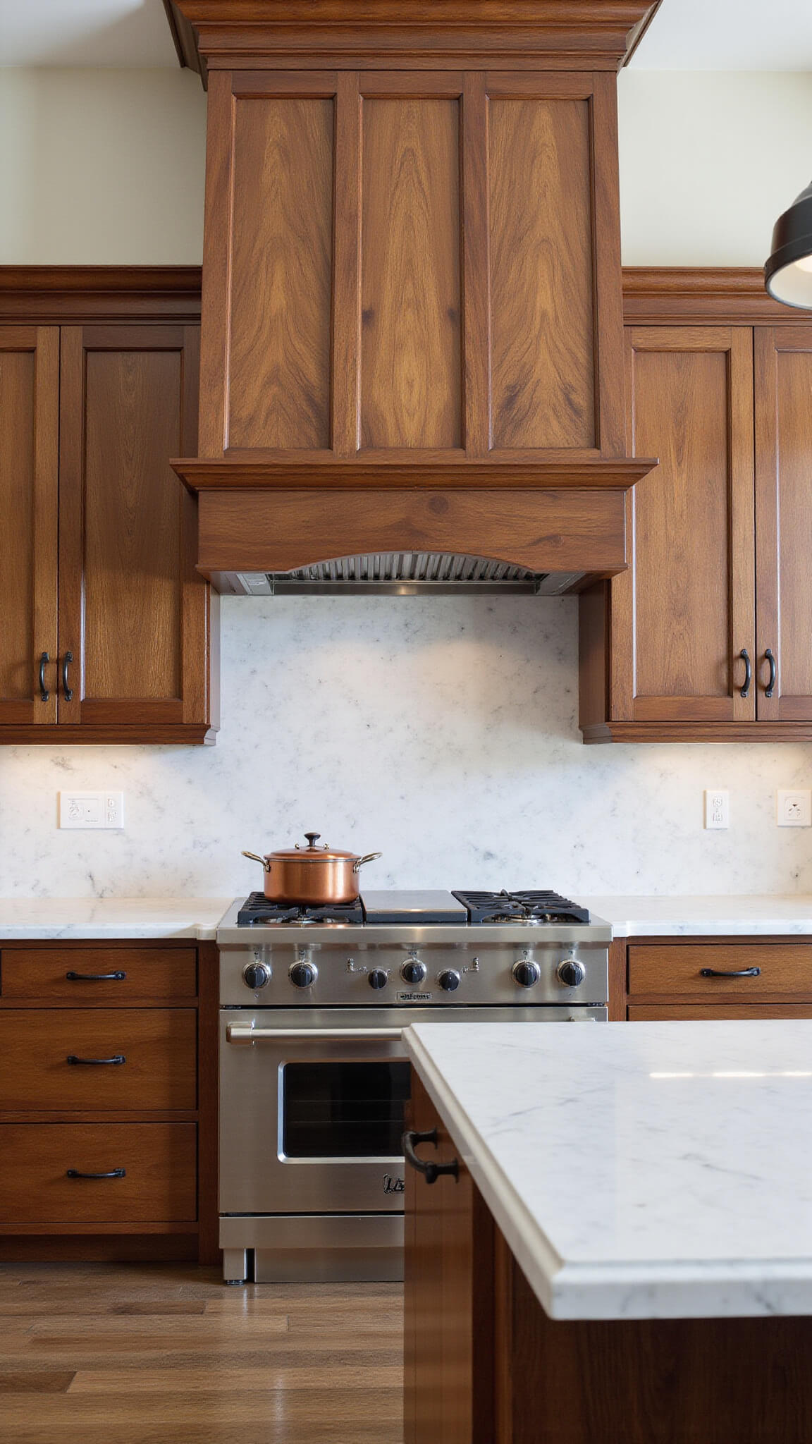 Luxurious 14x16ft chef's kitchen with book-matched walnut cabinets, stainless appliances, marble backsplash, and central black iron pot rack, shot in natural and soft light.