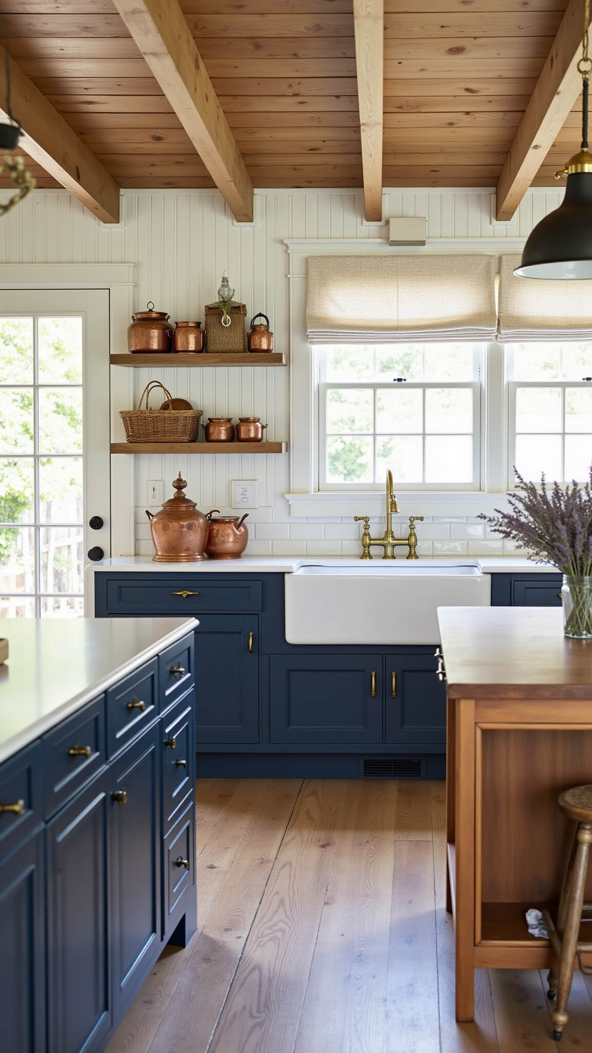 Rustic navy farmhouse kitchen with exposed beams, shiplap ceiling, butcher block island, and vintage copper accents.