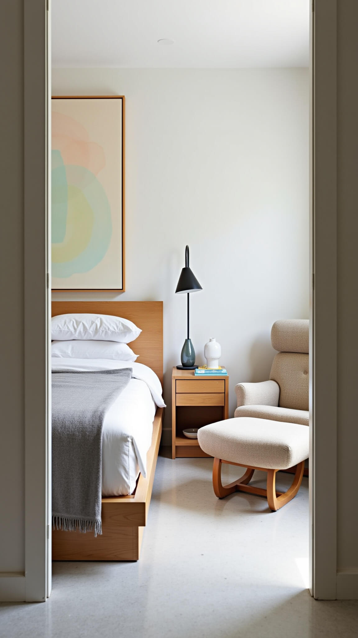 Scandinavian-MCM bedroom with white oak platform bed, terrazzo floors, Papa Bear chair, and soft pastel abstract art in bright natural light.