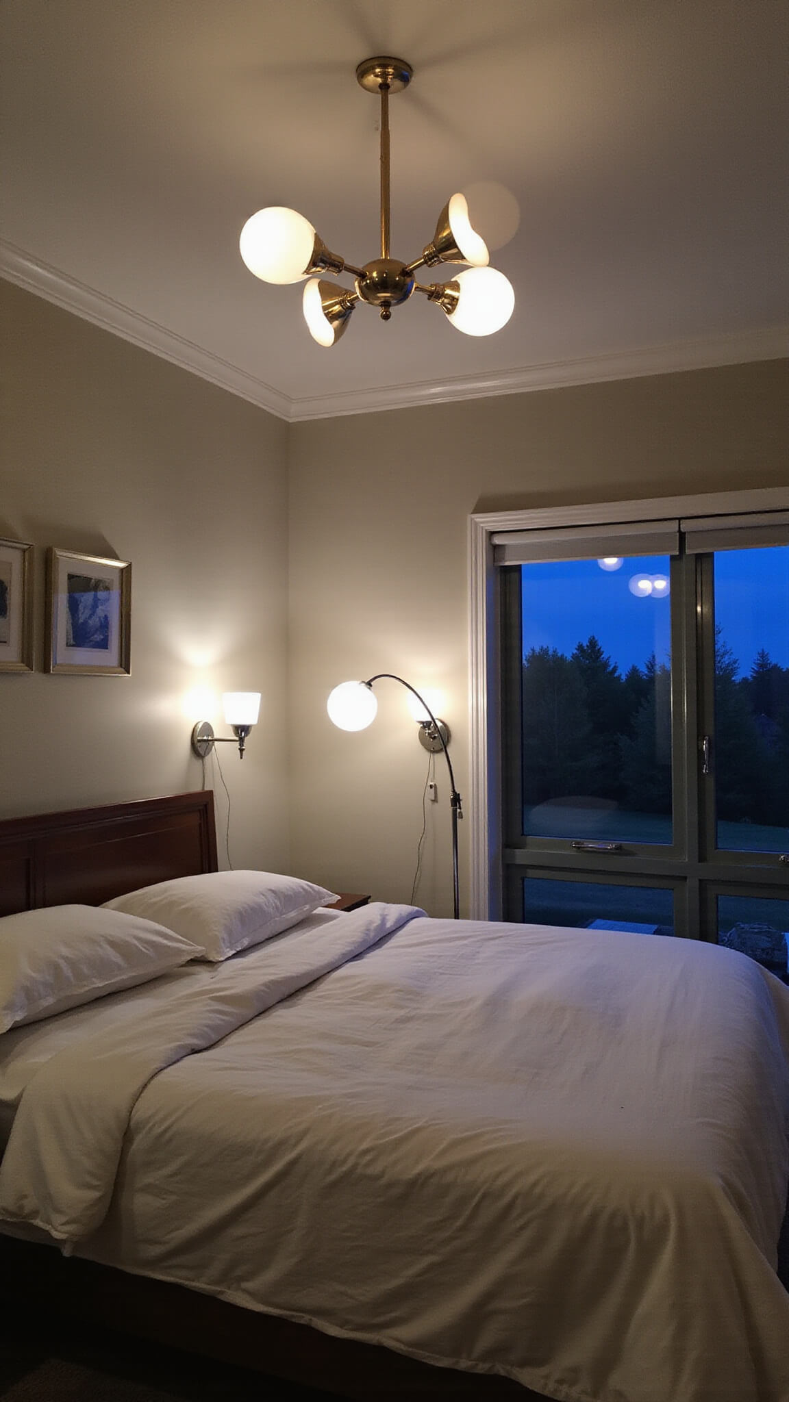 Modernist twilight bedroom with brass sputnik chandelier, white globe sconces, arc floor lamp, and warm ambient lighting.